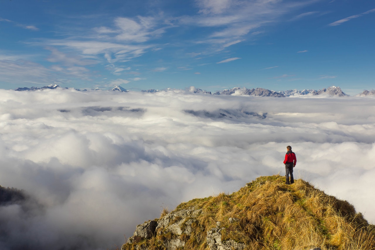 Man at the top of a peak